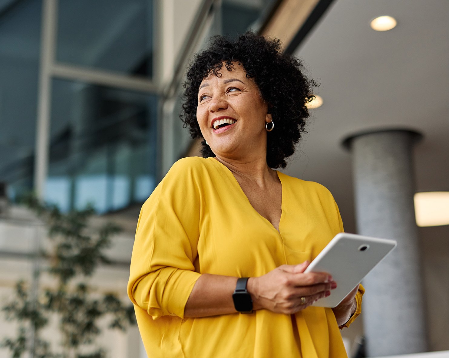 A-woman-in-an-office-using-a-tablet-device A-woman-in-an-office-using-a-tablet-device